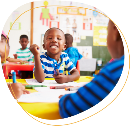 Preschool class in South Africa, boy looking to camera.