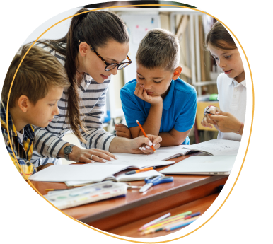 A kind female teacher spends time with her elementary school students, making learning enjoyable and fun while sparking curiosity and fostering a love for education.